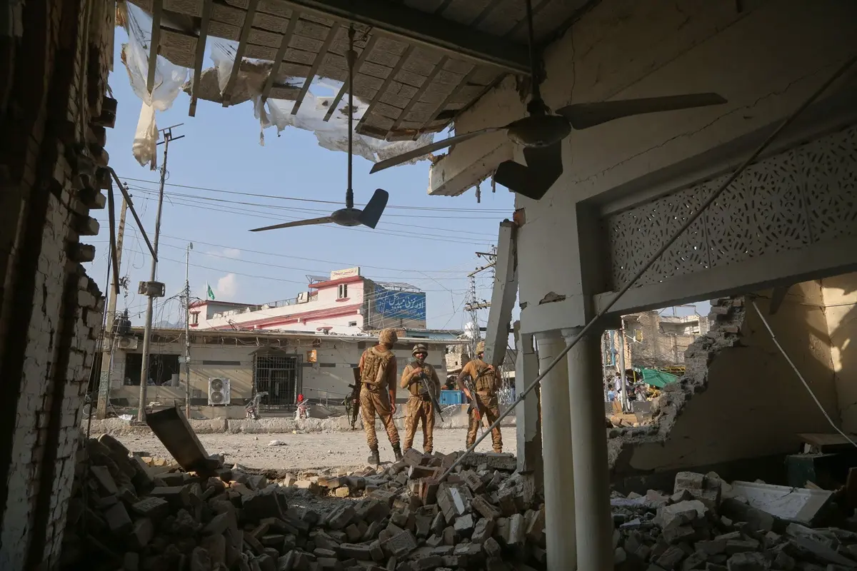 Army soldiers and members of media gather at the site of a powerful bomb exploded at a mosque in Kohat, in northwestern Pakistan | Photo: PTI