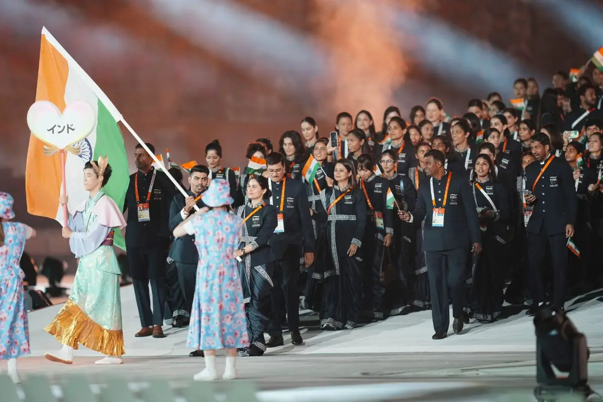 India's flag bearers Manu Bhaker and Pawan Kumar walk with teammates into the stadium during the opening ceremony for the Asian Games in Nagoya, Japan. | Photo: AP/PTI