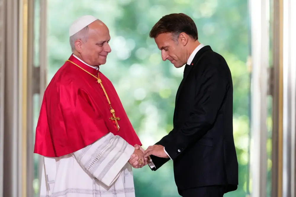 Pope Leo XIV, left, and French President Emmanuel Macron shake hands at the Elysee Palace | AP