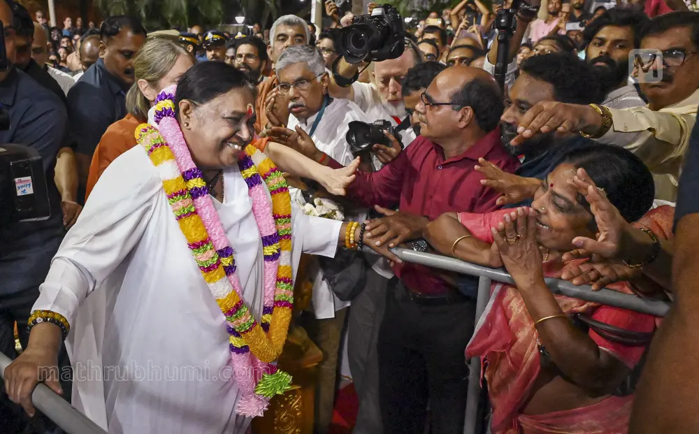 Spiritual leader Mata Amritanandamayi being greeted upon her arrival at the Kaimanam Ashram, in Thiruvananthapuram | PTI