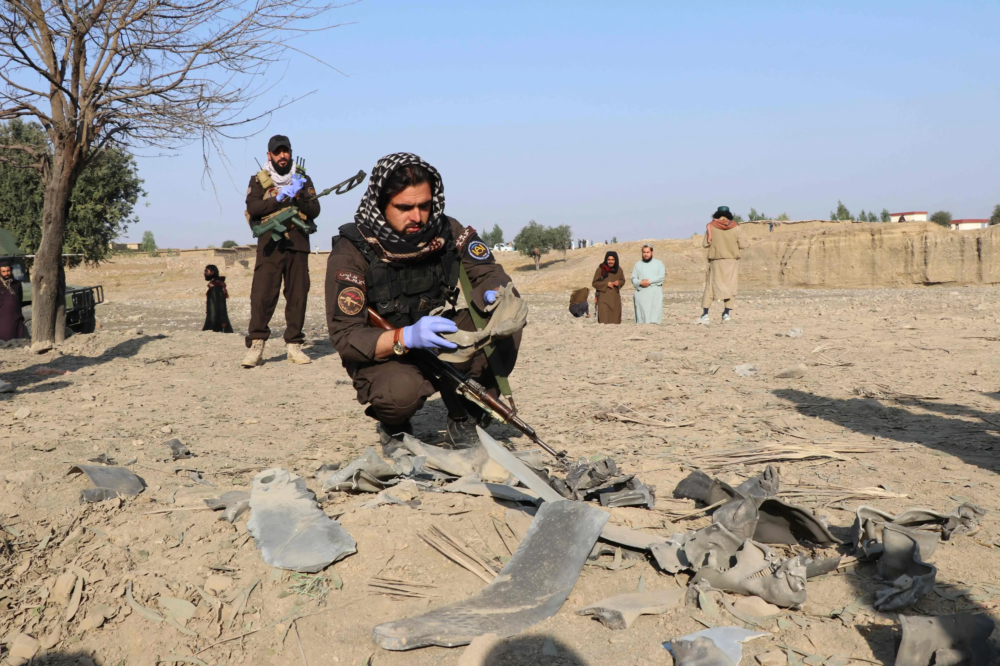 Taliban security personnel inspect the site after a Pakistani airstrike struck Gurbuz district in Afghanistan's Khost province on September 24