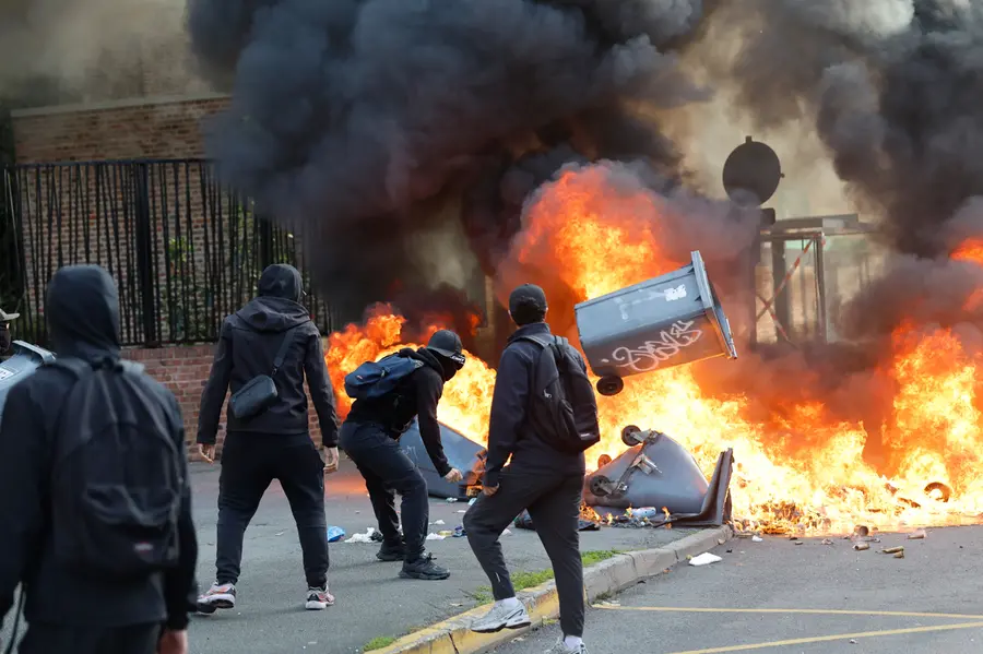 Students burn garbage as they protest to demand more resources at school, in Lille, France
