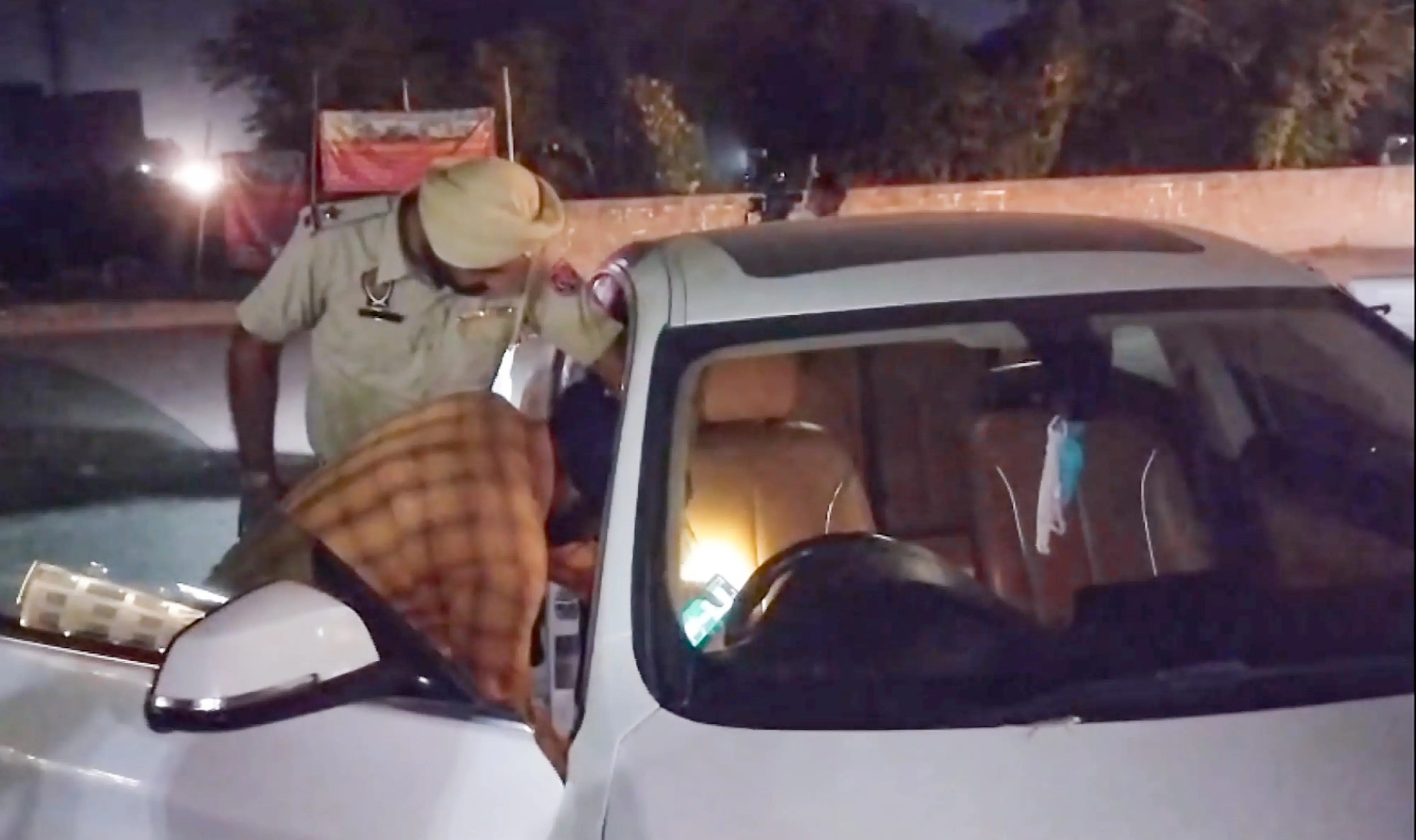 A police official inspect a car after Punjabi's social media influencer and makeup artist Mad Sandhu was shot dead by two motorcycle-borne unidentified persons, in Amritsar, Saturday, Oct. 3, 2026  | Photo: PTI