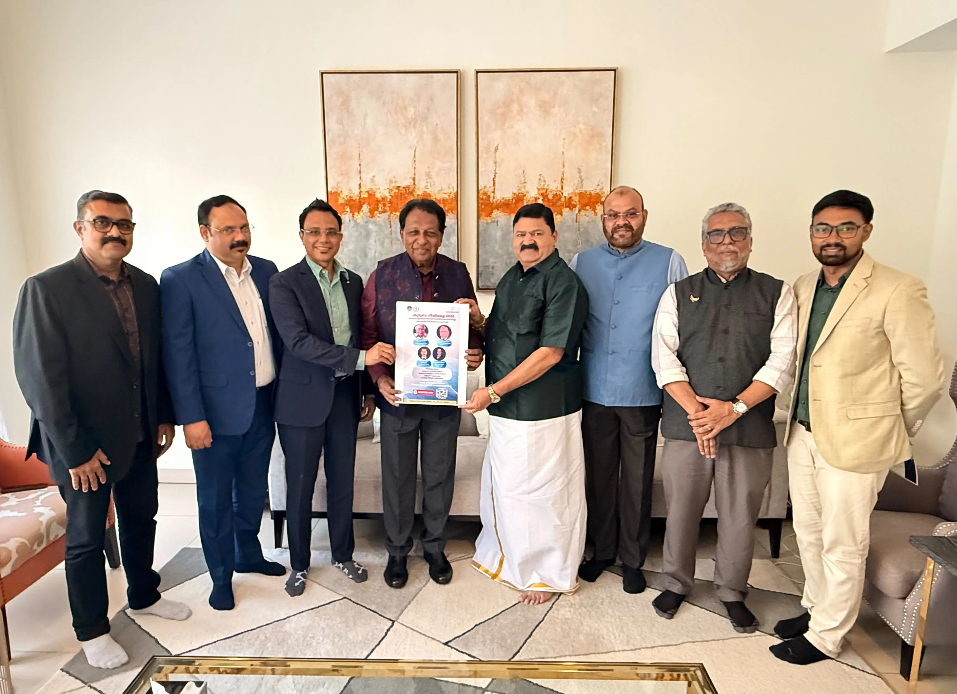 സൗജന്യ പ്രവാസി കുടുംബ നീതിമേളയുടെ പ്രചാരണ പോസ്റ്റര് മുൻ അംബാസഡര് ടി പി ശ്രീനിവാസൻ മോഹൻ എസ് വെങ്കിട്ടിനു നല്കി പ്രകാശനം ചെയ്യുന്നു.