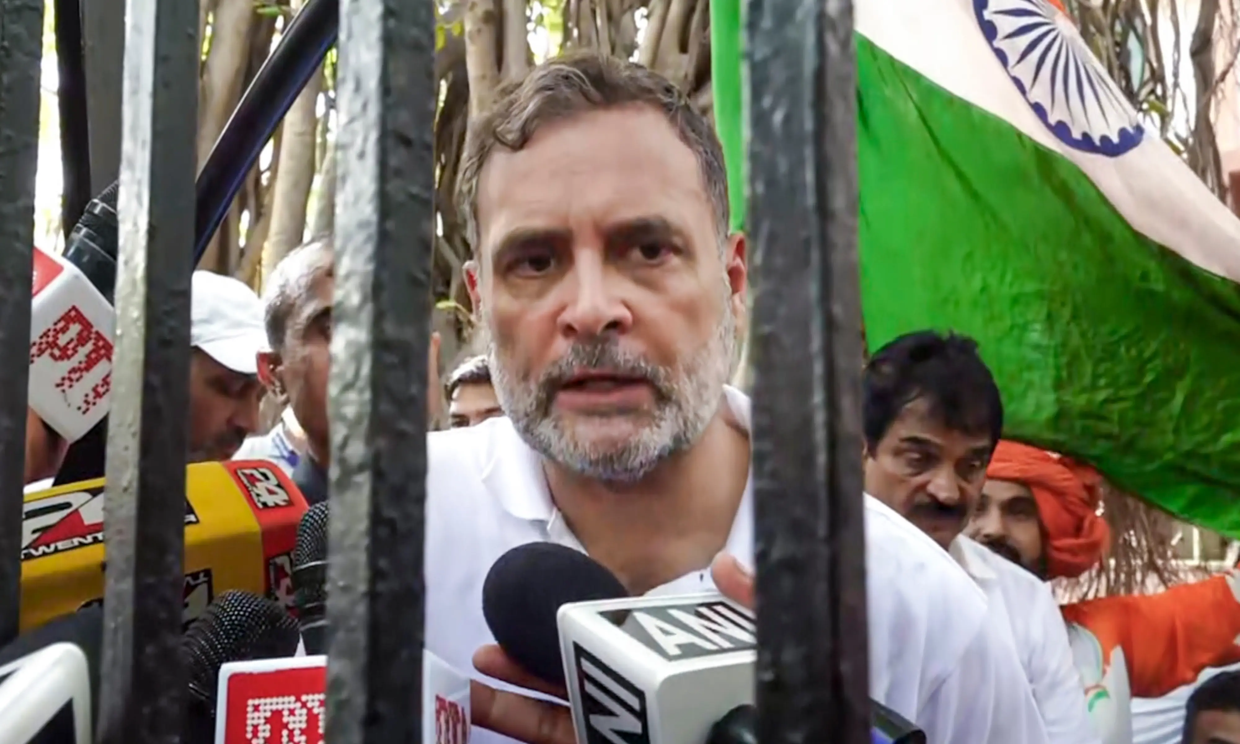 Leader of Opposition in the Lok Sabha Rahul Gandhi addresses media personnel through the gate of Akashvani Bhavan after being stopped by security forces during an INDIA bloc protest march towards the Election Commission of India (ECI) office, demanding the resignation of Chief Election Commissioner Gyanesh Kumar, in New Delhi.| Photo: PTI