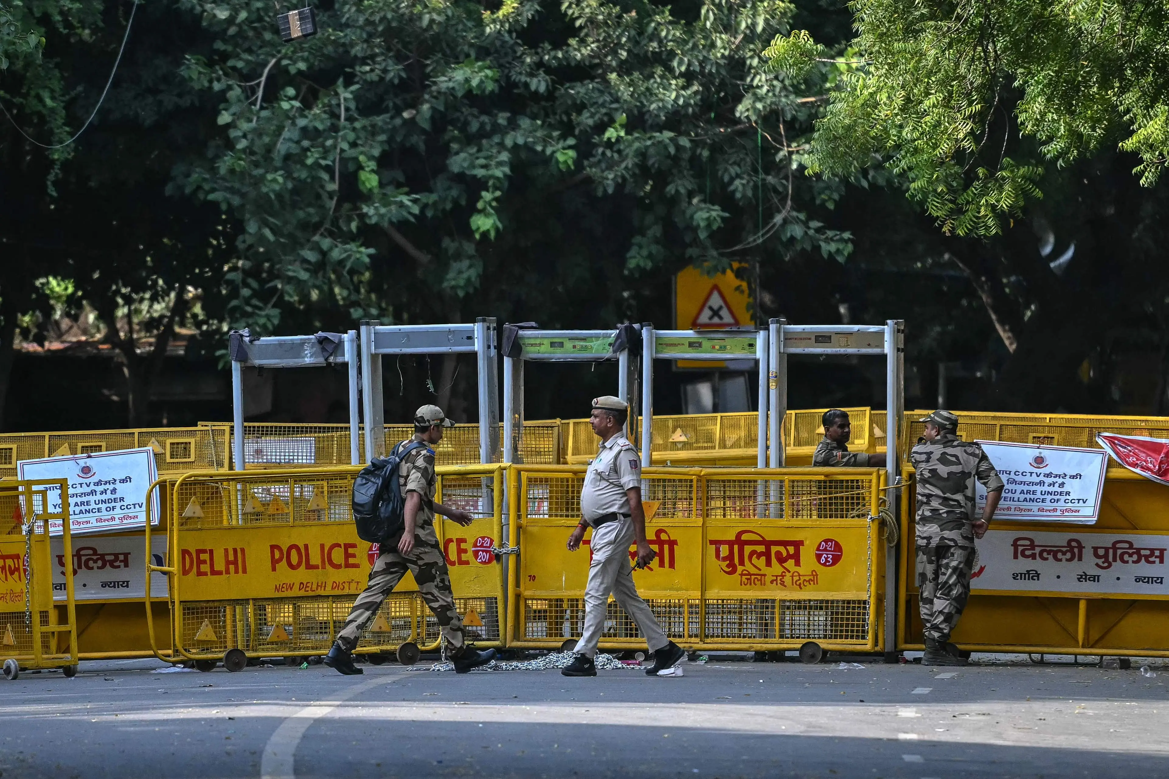 Security personnel walk past barricades installed at the Jantar Mantar protest site in New Delhi on October 9, 2026 on the eve of the planned protest against the country's Chief Election Commissioner Gyanesh Kumar over alleged voter-roll irregularities. Thousands of police were deployed across the Indian capital on October 9, a day before planned protests to demand the election commission chief step down over alleged voter-roll irregularities.| Photo: PTI