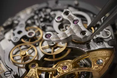 Inside a mechanical watch, what ticks beneath the dial