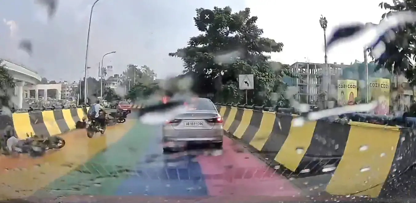 A dashcam captures the slippery, freshly painted Chingrighata flyover in Kolkata as motorcyclists fall on the rain-soaked stretch, raising concerns over road safety.