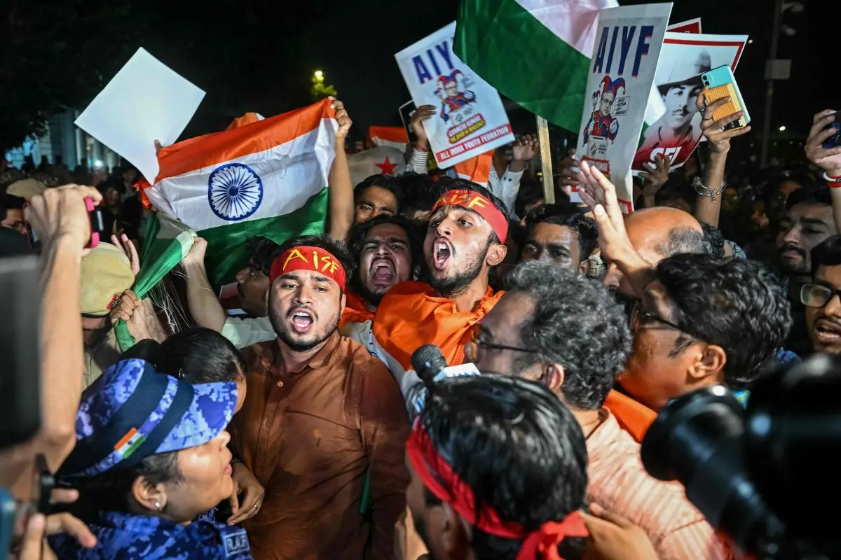 Cockroach Janta Party (CJP) supporters holding the country's national flags scuffle with security personnel during a protest demanding India's Chief Election Commissioner Gyanesh Kumar's resignation over alleged voter roll irregularities linked to the "special intensive revision" (SIR), at Connaught Place in New Delhi on October 16, 2026 (Photo: PTI)