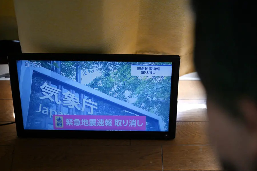 An advisory that reads \"Emergency Earthquake Alert Cancelled\" is seen on a television screen in Tokyo on October 16, 2026