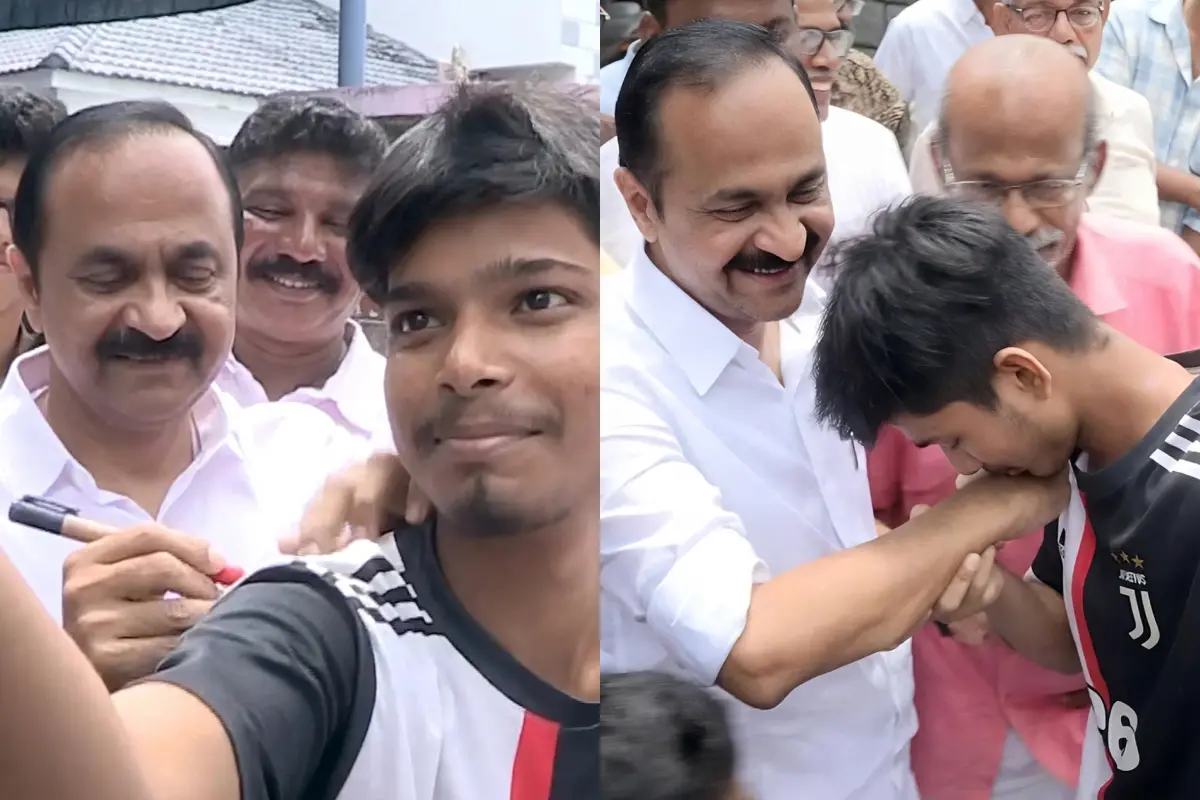 മുഖ്യമന്ത്രി വി.ഡി. സതീശന് ഖൈറുല് ഇസ്ലാമിന്റെ ടി-ഷര്ട്ടില് ഓട്ടോഗ്രാഫ് നല്കുന്നു, സതീശന്റെ കൈയില് ഖൈറുല് ചുംബിക്കുന്നു |