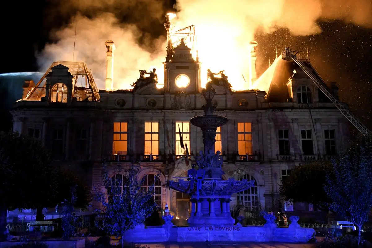 This photograph shows a fire burning and destroying the city hall after a group of individuals forced entry into the building during ongoing protest action against the "high cost of living", in Limoges, central France on October 17, 2026