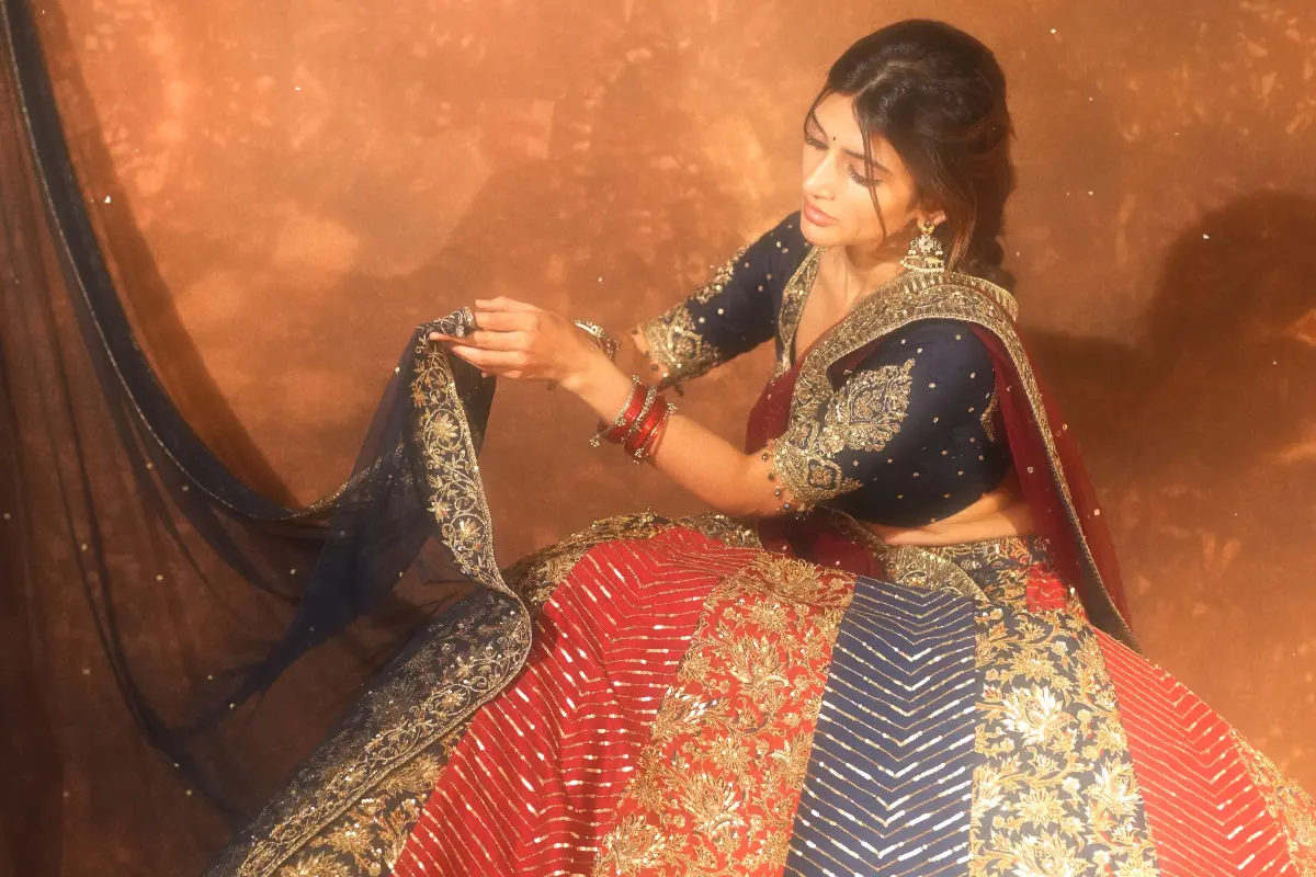 Sreeleela wears a crimson and indigo lehenga by Hyderabad-based designer Geethika Kanumilli. Photos | Instagram/@sreelala14