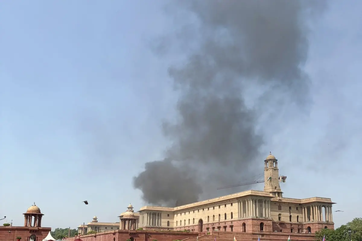 Thick smoke rises behind the North Block near Parliament in New Delhi, triggering an emergency response from fire services on Monday. The cause of the smoke remains unknown.