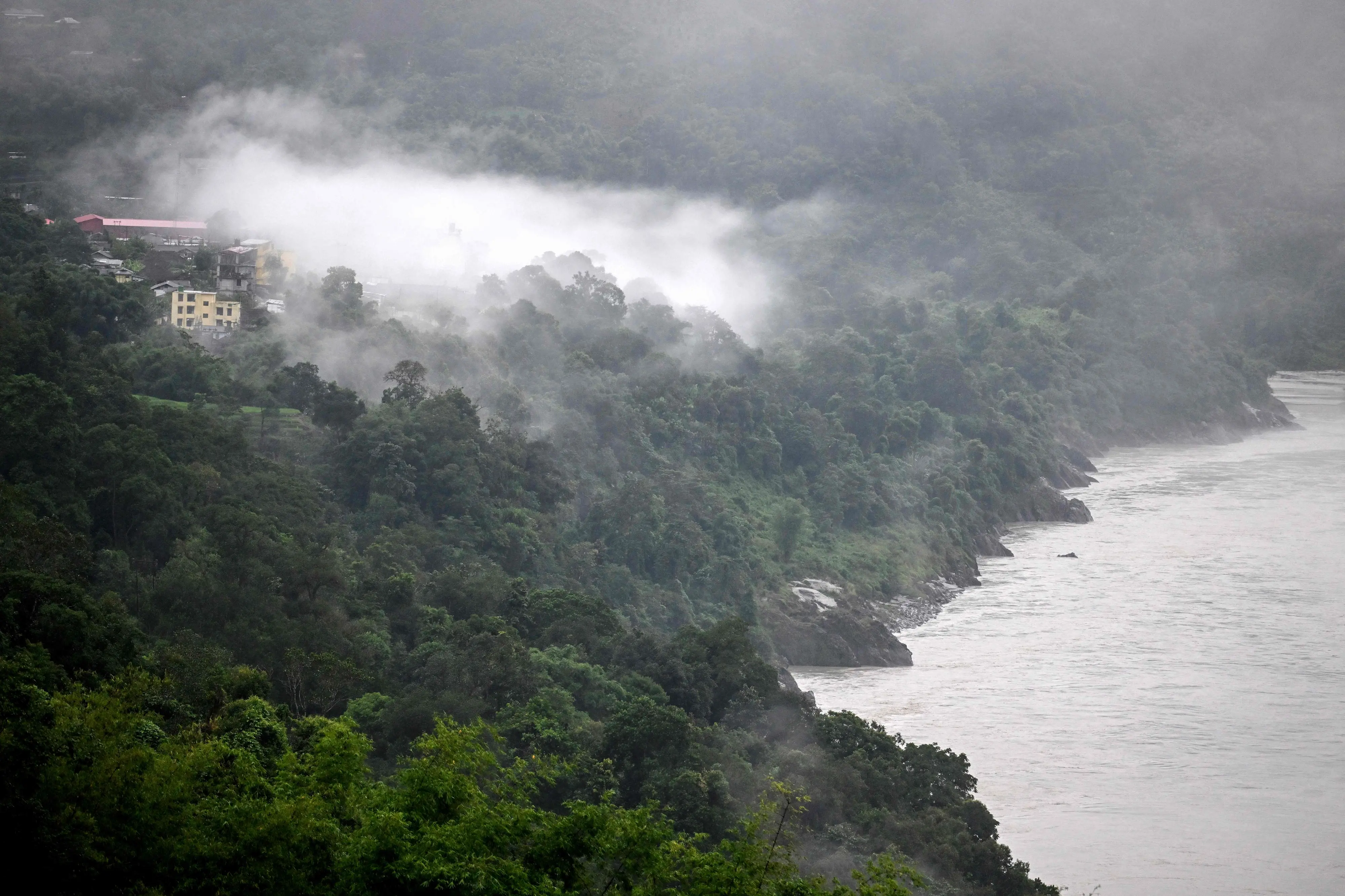 A general view of a settlement shrouded in mist facing potential risk of submersion owing to the Siang Upper Multipurpose Project (SUMP) on the Siang river, a proposed hydroelectric mega-dam project, at Geku village in the Upper Siang district of the northeastern state of Arunachal Pradesh.| Photo: PTI
