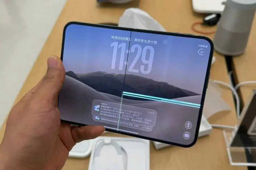 Apple iPhone Duo foldable smartphone displaying a severe screen crack along the hinge line