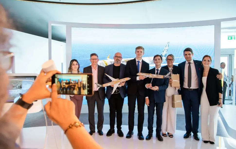The winners of the Airbus A350F Livery Design Competition celebrating alongside Airbus executives during the unveiling ceremony