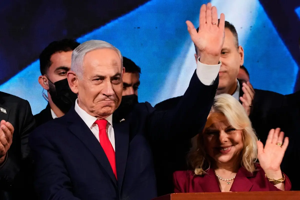 Israeli Prime Minister Benjamin Netanyahu, accompanied by his wife, Sara, waves to supporters at Likud party headquarters in Jerusalem after the release of the first exit poll results in Israel's general election, Wednesday, Oct. 28, 2026. (AP/PTI)